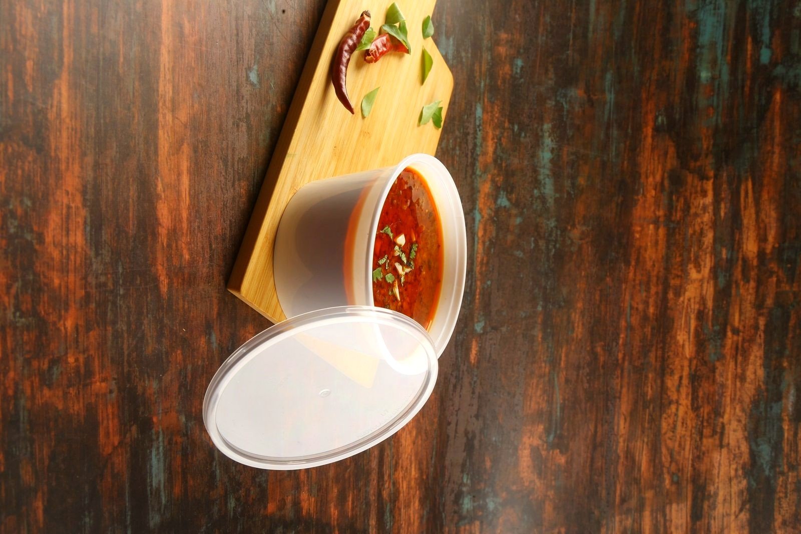 A clear Paras food container shown with its lid open